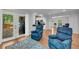 Open living room featuring hardwood floors, access to the deck, and comfortable seating at 1851 Mount Vernon Rd, Dunwoody, GA 30338