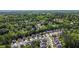 A serene aerial view of a quiet neighborhood featuring well-maintained homes nestled among mature trees at 5011 Weathervane Dr, Alpharetta, GA 30022