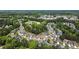 A stunning aerial view showcases a well-planned community surrounded by lush greenery and tree-lined streets at 5011 Weathervane Dr, Alpharetta, GA 30022