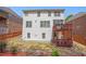 Exterior shot of the house showing a fenced backyard, deck areas, and neat landscaping for pleasant outdoor living at 5011 Weathervane Dr, Alpharetta, GA 30022