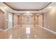 Spacious basement showcasing tile floors, columns, a window, and exterior door access at 5011 Weathervane Dr, Alpharetta, GA 30022
