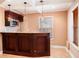Finished basement bar area with granite countertops, microwave, wine rack, and pendant lighting at 5011 Weathervane Dr, Alpharetta, GA 30022