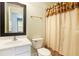 Cozy bathroom featuring a vanity, toilet, and shower with a decorative curtain at 5011 Weathervane Dr, Alpharetta, GA 30022