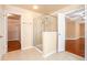 Bright bathroom featuring a glass-enclosed shower, tile floors, and access to a closet at 5011 Weathervane Dr, Alpharetta, GA 30022