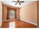 Neutral bedroom with hardwood flooring and large window bringing in natural light at 5011 Weathervane Dr, Alpharetta, GA 30022