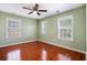 Bedroom with a large window, hardwood floors, and light green walls at 5011 Weathervane Dr, Alpharetta, GA 30022