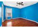 Bedroom with hardwood floors, a ceiling fan, and blue walls, creating a vibrant space at 5011 Weathervane Dr, Alpharetta, GA 30022