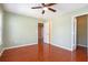 Bedroom with hardwood floors, closet, and an open doorway, offering a sense of spaciousness at 5011 Weathervane Dr, Alpharetta, GA 30022