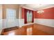 Elegant dining room featuring hardwood floors, wainscoting, a chandelier, and a bright window at 5011 Weathervane Dr, Alpharetta, GA 30022