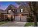 Charming two-story home with brick and siding, a two-car garage, and well-maintained front yard at 5011 Weathervane Dr, Alpharetta, GA 30022