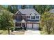 A stately two-story home with brick accents, symmetrical design, and a well-kept front lawn at 5011 Weathervane Dr, Alpharetta, GA 30022