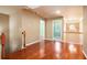 Hallway with hardwood floors and neutral paint, leading to other rooms in the house at 5011 Weathervane Dr, Alpharetta, GA 30022