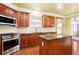 Well-lit kitchen featuring wood cabinets, granite countertops, and stainless steel appliances at 5011 Weathervane Dr, Alpharetta, GA 30022