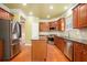 Modern kitchen with stainless steel refrigerator and an island for extra workspace at 5011 Weathervane Dr, Alpharetta, GA 30022