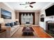 Stylishly furnished living room featuring hardwood floors, a fireplace, and large windows with ample light at 5011 Weathervane Dr, Alpharetta, GA 30022
