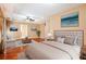 Staged bedroom featuring neutral decor, hardwood floors, and a tray ceiling, for a luxurious retreat at 5011 Weathervane Dr, Alpharetta, GA 30022