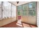 Bright sunroom featuring wood-look tile flooring, paneled walls, and large windows providing lots of natural light at 5011 Weathervane Dr, Alpharetta, GA 30022
