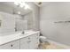 Well-lit bathroom with a single sink vanity, framed mirror, and neutral color palette at 4201 Stratford Commons, Decatur, GA 30033