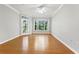 Bright and spacious empty room with hardwood floors and a doorway to an outdoor balcony at 4201 Stratford Commons, Decatur, GA 30033