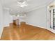 Open-concept living space with hardwood flooring, an exterior door, and a partial kitchen view at 4201 Stratford Commons, Decatur, GA 30033