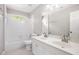 Well-lit bathroom with double sink vanity, white tile surround, and shower-tub combination at 4609 Mctyre Way, Marietta, GA 30064