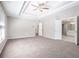 Spacious bedroom with neutral carpet and door into bathroom and closets at 4609 Mctyre Way, Marietta, GA 30064