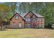Charming two-story home with a well-maintained lawn and mature trees in background at 4609 Mctyre Way, Marietta, GA 30064