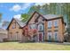 Beautiful home featuring a mix of stucco and stone exterior, complemented by a well-kept lawn at 4609 Mctyre Way, Marietta, GA 30064
