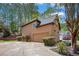 Exterior view of home and garage with tidy landscaping, paved driveway, and mature trees at 4609 Mctyre Way, Marietta, GA 30064