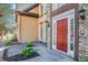 Stylish entryway with a red front door, stone accents, and manicured landscaping at 4609 Mctyre Way, Marietta, GA 30064