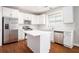 Modern kitchen featuring an island, white cabinets, stainless steel appliances, and stylish subway tile backsplash at 4609 Mctyre Way, Marietta, GA 30064