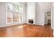 Bright living room featuring hardwood floors, a fireplace, and large windows at 4609 Mctyre Way, Marietta, GA 30064