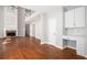Spacious living room with hardwood floors, a cozy fireplace, and a built-in desk area at 4609 Mctyre Way, Marietta, GA 30064