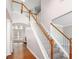 Staircase with hardwood railings and carpeted steps leading to the upper level of the home at 4609 Mctyre Way, Marietta, GA 30064
