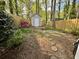 View of the shed in backyard with flower garden and stepping stones at 595 Saint James Se Walk, Marietta, GA 30067