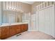 Bathroom featuring double sinks, shower with glass door, and closet space at 595 Saint James Se Walk, Marietta, GA 30067