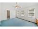 Large bedroom with three windows, a ceiling fan, with entry to a bathroom and outdoors at 595 Saint James Se Walk, Marietta, GA 30067