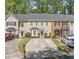 Front view of townhome, showing parking area and landscaping at 595 Saint James Se Walk, Marietta, GA 30067