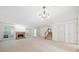 Large living room showcasing a brick fireplace, large windows, and easy access to the upper level at 595 Saint James Se Walk, Marietta, GA 30067