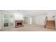 Bright living room featuring a brick fireplace, large windows, and a staircase at 595 Saint James Se Walk, Marietta, GA 30067