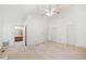 Bright main bedroom with carpet, ceiling fan, and two entrances to main bath at 595 Saint James Se Walk, Marietta, GA 30067