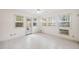 Inviting sunroom with tile floors, multiple windows, and a door to access the outside at 595 Saint James Se Walk, Marietta, GA 30067