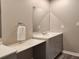 Bathroom featuring dual sinks, gray cabinets, and sleek vanity at 6401 Wedgeview Ct # 6401, Tucker, GA 30084