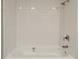 Clean white tub and shower with tiled surround and modern fixtures at 6401 Wedgeview Ct # 6401, Tucker, GA 30084