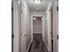Hallway with wood-look flooring and white doors leading to rooms at 6401 Wedgeview Ct # 6401, Tucker, GA 30084