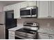 Modern kitchen with stainless steel appliances and white cabinetry at 6401 Wedgeview Ct # 6401, Tucker, GA 30084