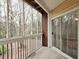 Covered patio with brick wall and sliding glass door overlooking wooded landscape at 6401 Wedgeview Ct # 6401, Tucker, GA 30084