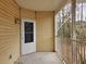 Covered porch with white door and view of surrounding trees at 6401 Wedgeview Ct # 6401, Tucker, GA 30084