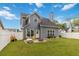Well-maintained home featuring a spacious backyard, white fence, and cozy patio area perfect for relaxing and entertaining at 900 Hillary Ln, Lawrenceville, GA 30043