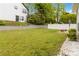 Spacious backyard featuring a retaining wall and white fence, providing privacy and ample space for outdoor activities at 900 Hillary Ln, Lawrenceville, GA 30043